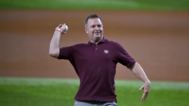Aug 4, 2023; Arlington, Texas, USA; Texas A&M Aggies baseball head coach Jim Schlossnagle throws out the first pitch before the game between the Texas Rangers and the Miami Marlins at Globe Life Field. Mandatory Credit: Jerome Miron-USA TODAY Sports