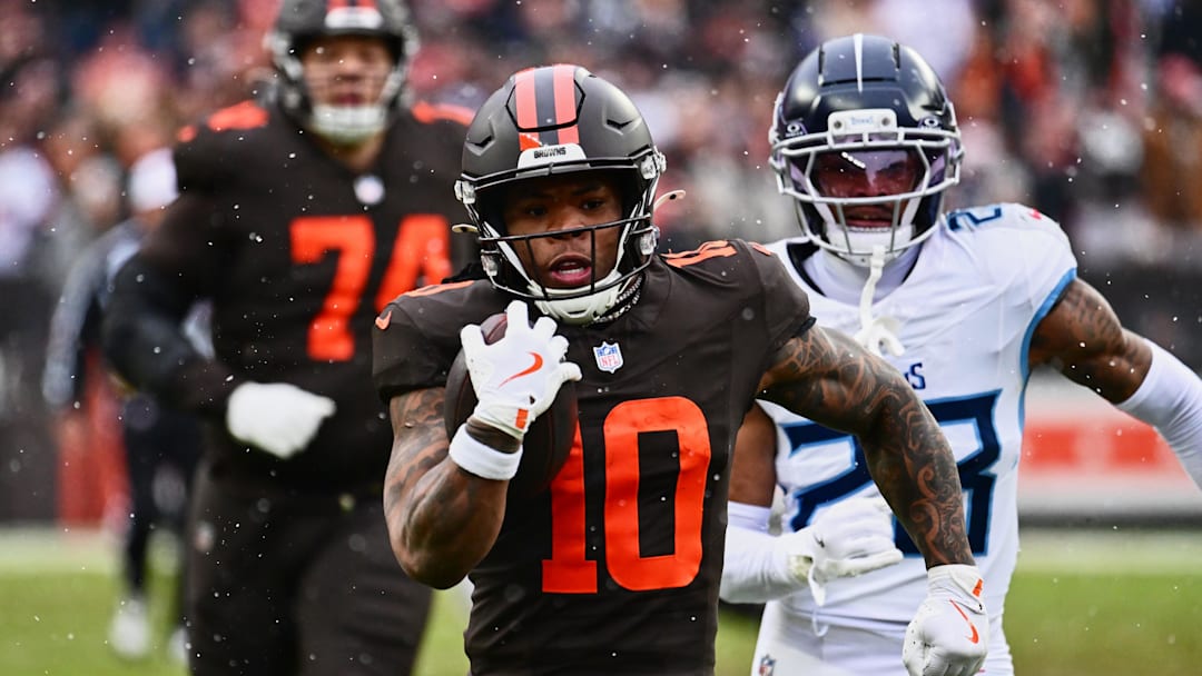 Dec 7, 2025; Cleveland, Ohio, USA; Cleveland Browns running back Quinshon Judkins (10) runs with the ball against Tennessee Titans safety Kevin Winston Jr. (23) during the first quarter at Huntington Bank Field. Mandatory Credit: Ken Blaze-Imagn Images