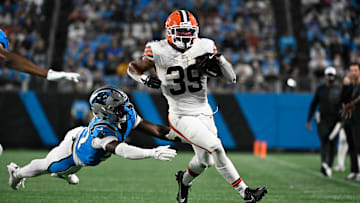 Aug 8, 2025; Charlotte, North Carolina, USA;  Cleveland Browns running back Ahmani Marshall (39) with the ball as Carolina Panthers linebacker Bam Martin-Scott (57) defends in the third quarter at Bank of America Stadium. Mandatory Credit: Bob Donnan-Imagn Images