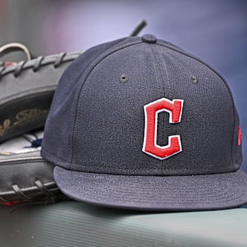 Jun 27, 2024; Kansas City, Missouri, USA; A general view a Cleveland Guardians hat and glove on the dugout railing  before a game against the Kansas City Royals at Kauffman Stadium. 