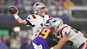 Nov 24, 2022; Minneapolis, Minnesota, USA; New England Patriots quarterback Mac Jones (10) throws a pass as Minnesota Vikings linebacker Danielle Hunter (99) rushes in during the first quarter at U.S. Bank Stadium. Mandatory Credit: Jeffrey Becker-Imagn Images