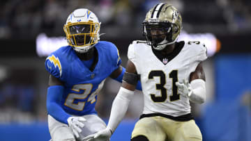 Aug 20, 2023; Inglewood, California, USA; Los Angeles Chargers safety AJ Finley (24) and New Orleans Saints safety Jordan Howden (31) battle during a punt return during the second half at SoFi Stadium. Mandatory Credit: Orlando Ramirez-USA TODAY Sports 