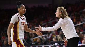 Feb 8, 2025; Los Angeles, California, USA; USC Trojans guard JuJu Watkins (12) celebrates with head coach Lindsay Gottlieb in the fourth quarter against the Ohio State Buckeyes at Galen Center. 