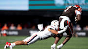 Cincinnati Bearcats safety Tayden Barnes (10) tackles Bowling Green Falcons tight end Jyrin Johnson (7) in the second quarter of the NCAA football game between the Cincinnati Bearcats and Bowling Green Falcons at Nippert Stadium in Cincinnati on Sept. 6, 2025.