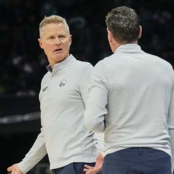 Oct 29, 2022; Charlotte, North Carolina, USA; Golden State Warriors head coach Steve Kerr reacts to a foul call talking with assistant Kenny Atkinson during the second half against the Charlotte Hornets at Spectrum Center. Mandatory Credit: Jim Dedmon-USA TODAY Sports