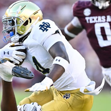 Aug 31, 2024; College Station, Texas, USA; Notre Dame Fighting Irish running back Jeremiyah Love (4) is tackled by Texas A&M Aggies defensive back Jayvon Thomas (14) in the first quarter at Kyle Field. 