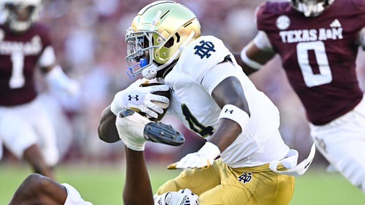 Aug 31, 2024; College Station, Texas, USA; Notre Dame Fighting Irish running back Jeremiyah Love (4) is tackled by Texas A&M Aggies defensive back Jayvon Thomas (14) in the first quarter at Kyle Field. 