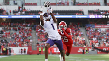 Nov 22, 2025; Houston, Texas, USA; TCU Horned Frogs wide receiver Eric McAlister (1) makes a reception for a touchdown as Houston Cougars defensive back Will James (15) defends during the first quarter at TDECU Stadium. Mandatory Credit: Troy Taormina-Imagn Images