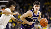 Jan 19, 2025; Ann Arbor, Michigan, USA;  Northwestern Wildcats guard Brooks Barnhizer (13) dribbles defended by Michigan Wolverines guard Tre Donaldson (3) in the second half at Crisler Center. Mandatory Credit: Rick Osentoski-Imagn Images