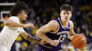 Jan 19, 2025; Ann Arbor, Michigan, USA;  Northwestern Wildcats guard Brooks Barnhizer (13) dribbles defended by Michigan Wolverines guard Tre Donaldson (3) in the second half at Crisler Center. Mandatory Credit: Rick Osentoski-Imagn Images