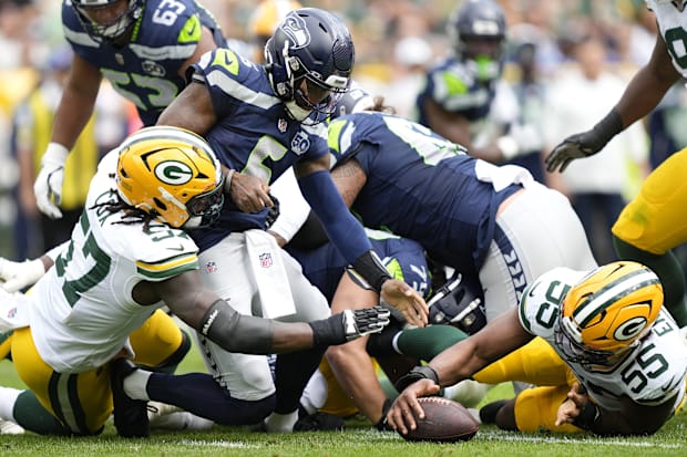 Green Bay Packers defensive end Kingsley Enagbare (55) recovers a fumble forced by Brenton Cox.