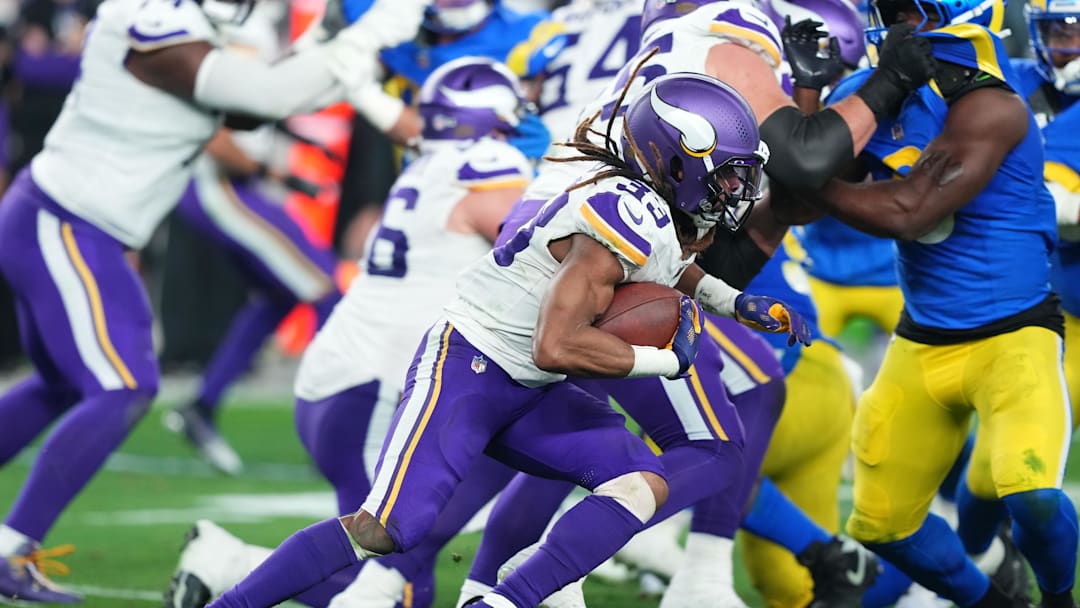 Jan 13, 2025; Glendale, AZ, USA; Minnesota Vikings running back Aaron Jones (33) rushes the ball against the Los Angeles Rams during the second half in an NFC wild card game at State Farm Stadium. Mandatory Credit: Joe Camporeale-Imagn Images