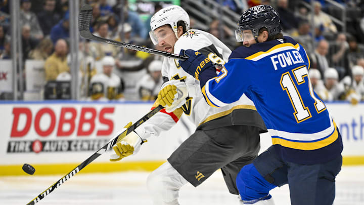 Jan 23, 2025; St. Louis, Missouri, USA;  Vegas Golden Knights right wing Mark Stone (61) steals the puck from St. Louis Blues defenseman Cam Fowler (17) during the first period at Enterprise Center. Mandatory Credit: Jeff Curry-Imagn Images