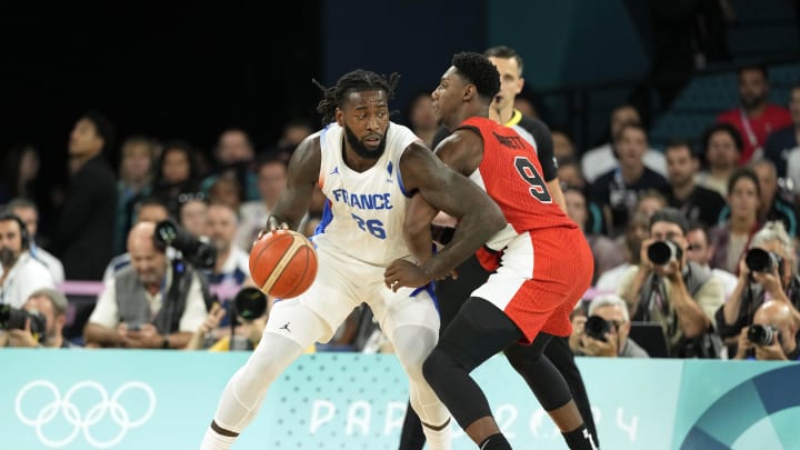 Aug 6, 2024; Paris, France;  France centre Mathias Lessort (26) controls the ball against Canada small forward RJ Barrett (9) in the first quarter in a men’s basketball quarterfinal game during the Paris 2024 Olympic Summer Games at Accor Arena. Mandatory Credit: Kyle Terada-USA TODAY Sports