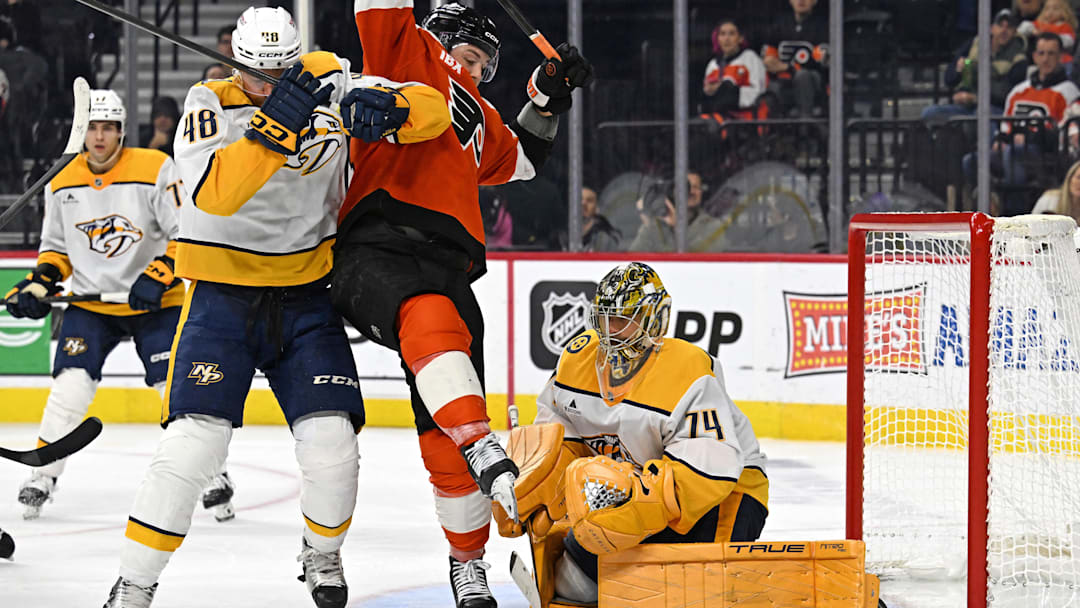 Oct 30, 2025; Philadelphia, Pennsylvania, USA; Nashville Predators defenseman Nick Perbix (48) battles with Philadelphia Flyers right wing Tyson Foerster (71) in front of  goaltender Juuse Saros (74) during the third period at Xfinity Mobile Arena. Mandatory Credit: Eric Hartline-Imagn Images