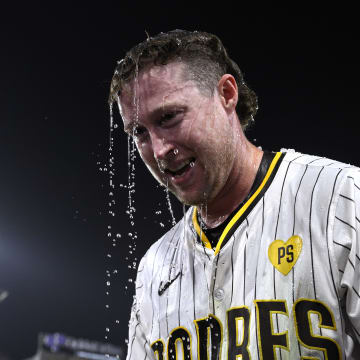 Jun 20, 2024; San Diego, California, USA; San Diego Padres second baseman Jake Cronenworth (9) looks on after being doused after hitting a walk-off home run during the ninth inning against the Milwaukee Brewers at Petco Park. Mandatory Credit: Orlando Ramirez-USA TODAY Sports