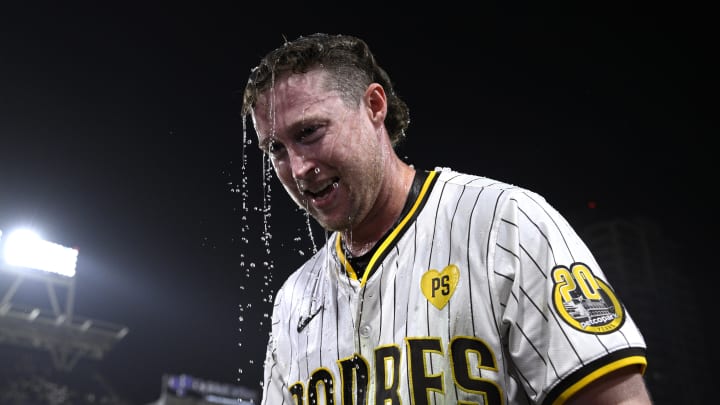Jun 20, 2024; San Diego, California, USA; San Diego Padres second baseman Jake Cronenworth (9) looks on after being doused after hitting a walk-off home run during the ninth inning against the Milwaukee Brewers at Petco Park. Mandatory Credit: Orlando Ramirez-USA TODAY Sports