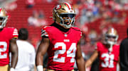 Jordan Mason warms up before a game last season as a member of the 49ers. 