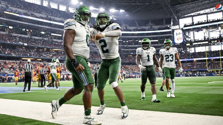 Jan 2, 2023; Arlington, Texas, USA; Tulane Green Wave defensive lineman Patrick Jenkins (0) and linebacker Dorian Williams (2) celebrate during the game between the USC Trojans and the Tulane Green Wave in the 2023 Cotton Bowl at AT&T Stadium. 