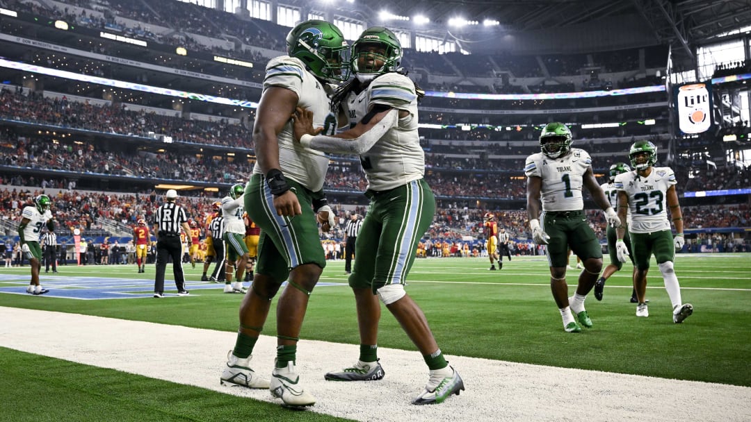 Jan 2, 2023; Arlington, Texas, USA; Tulane Green Wave defensive lineman Patrick Jenkins (0) and linebacker Dorian Williams (2) celebrate during the game between the USC Trojans and the Tulane Green Wave in the 2023 Cotton Bowl at AT&T Stadium.