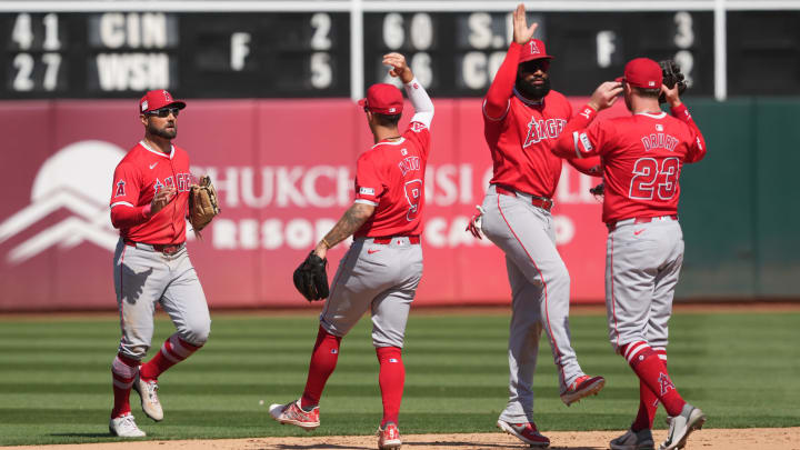 Jul 21, 2024; Oakland, California, USA; (L to R) Los Angeles Angels center fielder Kevin Pillar celebrates on the field with shortstop Zach Neto (9) and right fielder Jo Adell (7) and second baseman Brandon Drury (23) after defeating the Oakland Athletics at Oakland-Alameda County Coliseum.