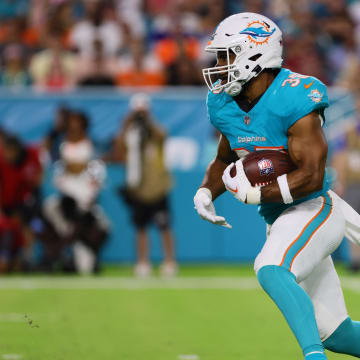 Miami Dolphins running back Chris Brooks (35) runs with the football against the Washington Commanders during the second quarter of a preseason game at Hard Rock Stadium.