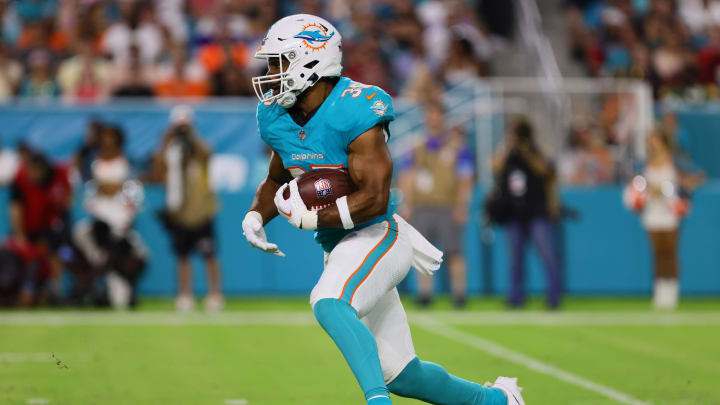 Miami Dolphins running back Chris Brooks (35) runs with the football against the Washington Commanders during the second quarter of a preseason game at Hard Rock Stadium.