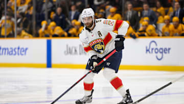 Feb 25, 2025; Nashville, Tennessee, USA;  Florida Panthers defenseman Aaron Ekblad (5) skates with the puck against the Nashville Predators during the second period at Bridgestone Arena. Mandatory Credit: Steve Roberts-Imagn Images
