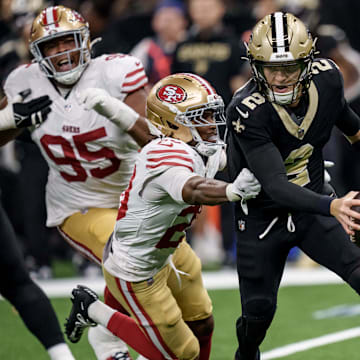 Sep 14, 2025; New Orleans, Louisiana, USA; New Orleans Saints quarterback Spencer Rattler (2) runs from San Francisco 49ers cornerback Upton Stout (20) during the second half at Caesars Superdome. Mandatory Credit: Matthew Hinton-Imagn Images
