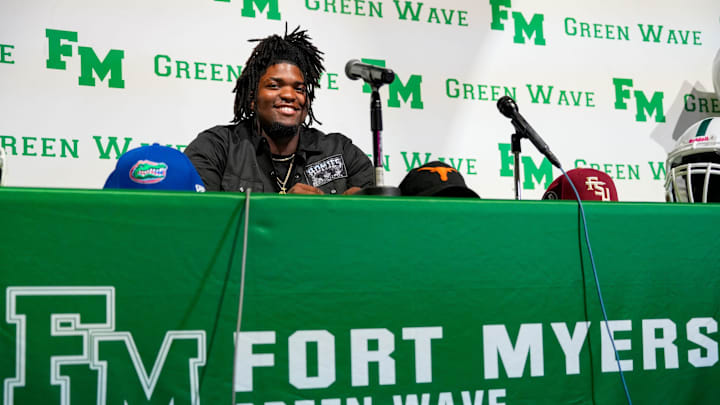 Fort Myers Green Wave defensive lineman Kendall Guervil commits to the University of Florida while surrounded by friends and family during a ceremony at Fort Myers High School in Fort Myers, Fla., on Wednesday, July 2, 2025.
