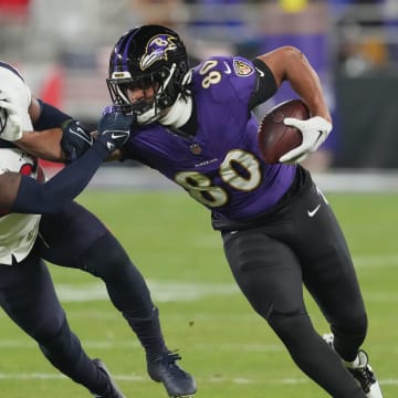 Jan 20, 2024; Baltimore, MD, USA; Baltimore Ravens tight end Isaiah Likely (80) runs the ball against Houston Texans cornerback Desmond King II (25) during the third quarter of a 2024 AFC divisional round game at M&T Bank Stadium. Mandatory Credit: Mitch Stringer-USA TODAY Sports