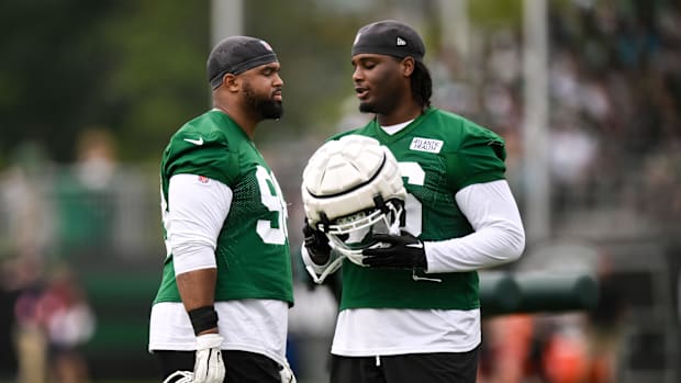 New York Jets defensive tackle Bruce Hector (98) and defensive tackle Leonard Taylor III (96) talk.