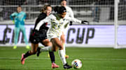 Dec 6, 2024; Cary, NC, USA; Wake Forest midfielder Caiya Hanks (9) with the ball as Stanford forward Allie Montoya (3) pressures in the second half at WakeMed Soccer Park. Mandatory Credit: Bob Donnan-Imagn Images