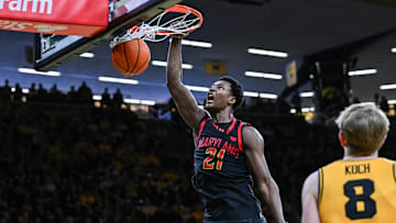 Dec 6, 2025; Iowa City, Iowa, USA; Maryland Terrapins forward Pharrel Payne (21) completes a slam dunk against the Iowa Hawkeyes during the first half at Carver-Hawkeye Arena. Mandatory Credit: Jeffrey Becker-Imagn Images