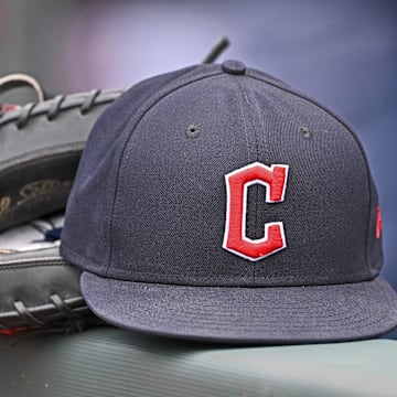 Jun 27, 2024; Kansas City, Missouri, USA; A general view a Cleveland Guardians hat and glove on the dugout railing  before a game against the Kansas City Royals at Kauffman Stadium. 