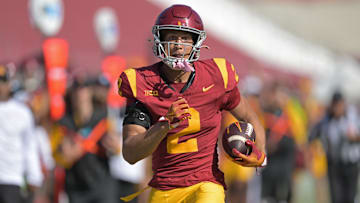 Oct 12, 2024; Los Angeles, California, USA;  USC Trojans wide receiver Duce Robinson (2) runs the ball after a complete pass before he is stopped by Penn State Nittany Lions safety Zakee Wheatley (6) in the second half at United Airlines Field at the Los Angeles Memorial Coliseum. Mandatory Credit: Jayne Kamin-Oncea-Imagn Images