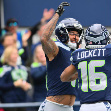 Oct 22, 2023; Seattle, Washington, USA; Seattle Seahawks wide receiver Jaxon Smith-Njigba (11) and Seattle Seahawks wide receiver Tyler Lockett (16) celebrate after Jaxon Smith-Njigba scored a touchdown against the Arizona Cardinals during the first half at Lumen Field.