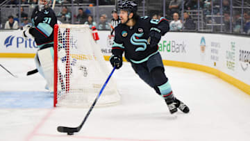 Dec 14, 2024; Seattle, Washington, USA; Seattle Kraken left wing Brandon Tanev (13) plays the puck during the second period against the Tampa Bay Lightning at Climate Pledge Arena. Mandatory Credit: Steven Bisig-Imagn Images