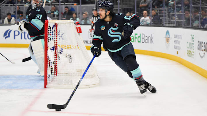 Dec 14, 2024; Seattle, Washington, USA; Seattle Kraken left wing Brandon Tanev (13) plays the puck during the second period against the Tampa Bay Lightning at Climate Pledge Arena. Mandatory Credit: Steven Bisig-Imagn Images