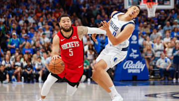 Apr 7, 2024; Dallas, Texas, USA; Dallas Mavericks guard Dante Exum (0) is called for a foul against Houston Rockets guard Fred VanVleet (5) during the fourth quarter at American Airlines Center. Mandatory Credit: Andrew Dieb-Imagn Images