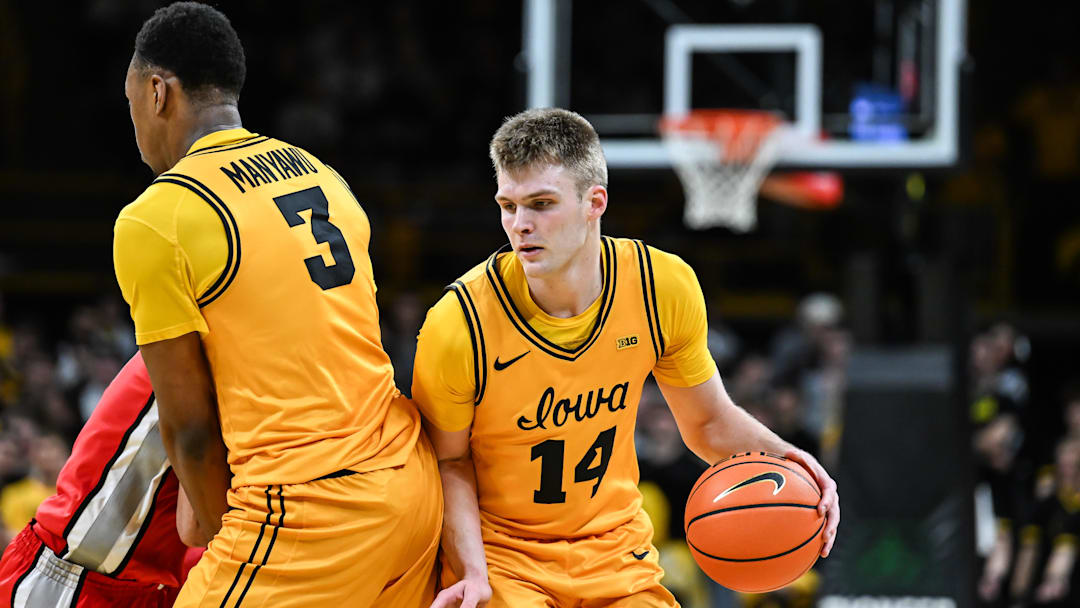 Feb 25, 2026; Iowa City, Iowa, USA; Iowa Hawkeyes guard Bennett Stirtz (14) controls the ball as forward Cam Manyawu (3) sets a screen against the Ohio State Buckeyes during the second half at Carver-Hawkeye Arena. Mandatory Credit: Jeffrey Becker-Imagn Images