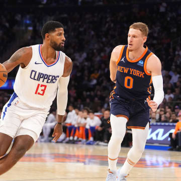 Nov 6, 2023; New York, New York, USA; Los Angeles Clipper forward Paul George (13) dribbles the ball against New York Knicks shooting guard Donte DiVincenzo (0) during the fourth quarter at Madison Square Garden. Mandatory Credit: Gregory Fisher-USA TODAY Sports
