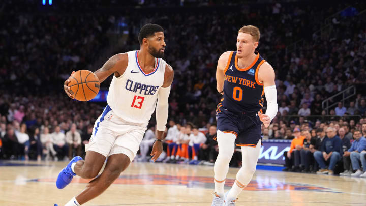 Nov 6, 2023; New York, New York, USA; Los Angeles Clipper forward Paul George (13) dribbles the ball against New York Knicks shooting guard Donte DiVincenzo (0) during the fourth quarter at Madison Square Garden. Mandatory Credit: Gregory Fisher-USA TODAY Sports