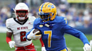 Oct 25, 2025; Pittsburgh, Pennsylvania, USA;  Pittsburgh Panthers wide receiver Duece Spann (7) runs after  catch as North Carolina State Wolfpack safety Ronnie Royal III (2) chases during the second quarter at Acrisure Stadium. Mandatory Credit: Charles LeClaire-Imagn Images
