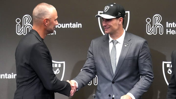 Apr 24, 2026; Henderson, NV, USA; Las Vegas Raiders quarterback Fernando Mendoza (right) shakes hands with general manager John Spytek at introductory press conference at Intermountain Health Performance Center after being selected as the No. 1 pick in the 2026 NFL Draft. Mandatory Credit: Kirby Lee-Imagn Images
