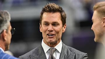 Dec 29, 2024; Minneapolis, Minnesota, USA;  FOX broadcaster and former NFL quarterback Tom Brady looks on before the game between the Minnesota Vikings and the Green Bay Packers at U.S. Bank Stadium. Mandatory Credit: Jeffrey Becker-Imagn Images