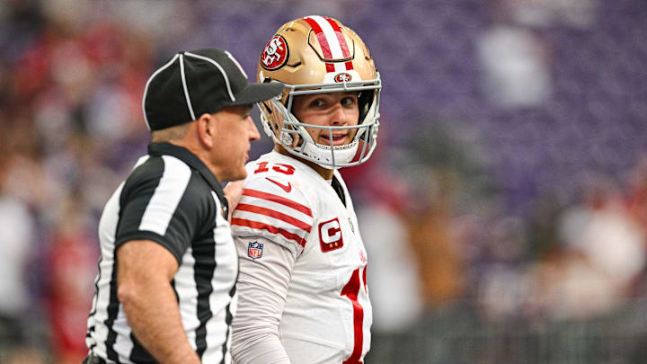 Sep 15, 2024; Minneapolis, Minnesota, USA; San Francisco 49ers quarterback Brock Purdy (13) talks with an official before the game against the Minnesota Vikings at U.S. Bank Stadium. Mandatory Credit: Jeffrey Becker-Imagn Images