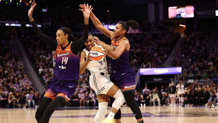 Jul 14, 2025; San Francisco, California, USA; Golden State Valkyries forward Kayla Thornton (5) controls the ball between Phoenix Mercury guard DeWanna Bonner (14) and forward Alyssa Thomas (25) during the fourth quarter at Chase Center. Mandatory Credit: Kelley L Cox-Imagn Images