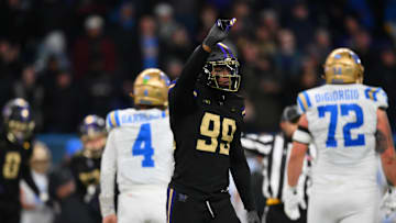 Nov 15, 2024; Seattle, Washington, USA; Washington Huskies defensive lineman Russell Davis II (99) celebrates after sacking UCLA Bruins quarterback Ethan Garbers (4) during the second half at Alaska Airlines Field at Husky Stadium. Mandatory Credit: Steven Bisig-Imagn Images