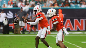 Sep 14, 2024; Miami Gardens, Florida, USA; Miami Hurricanes quarterback Cam Ward (1) catches the snap against the Ball State Cardinals during the first quarter at Hard Rock Stadium. Mandatory Credit: Sam Navarro-Imagn Images